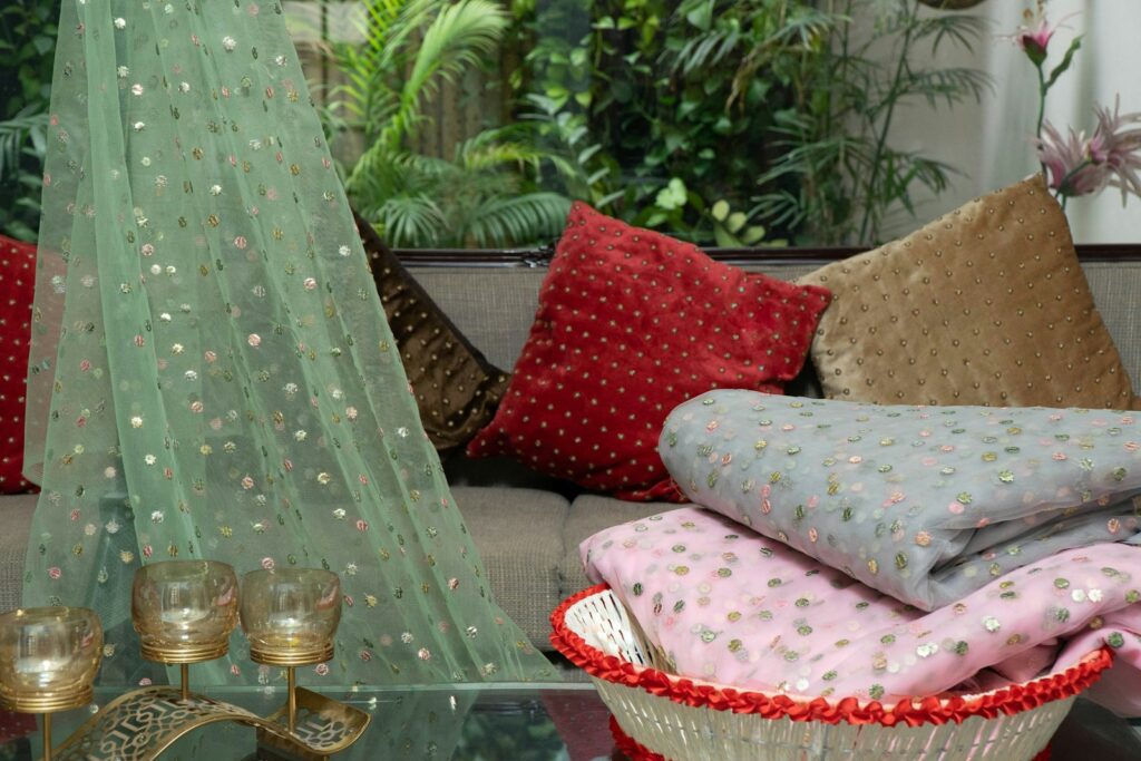 a glass table topped with lots of pillows
